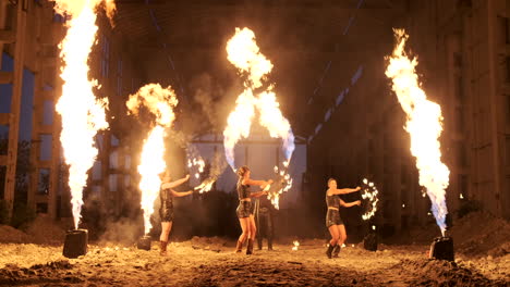 A-group-of-professional-artists-with-fire-show-the-show-juggling-and-dancing-with-fire-in-slow-motion
